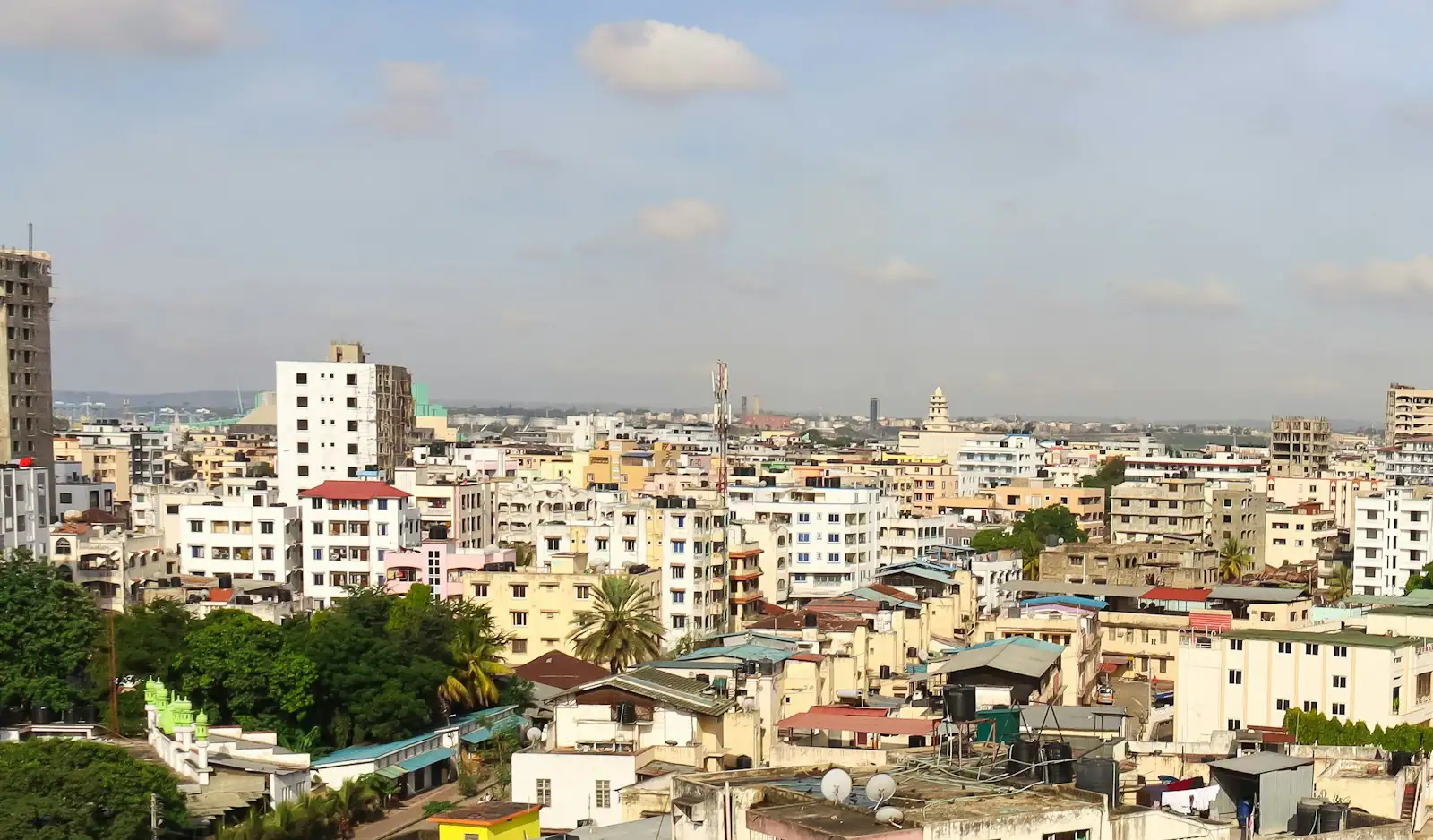 Mombasa's rooftops under a partly cloudy sky, seen from above